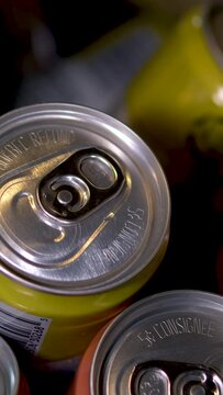 Tin cans with soda or beer stand in rows on the warehouse or supermarket shelf. Closeup shot. High quality 4k footage