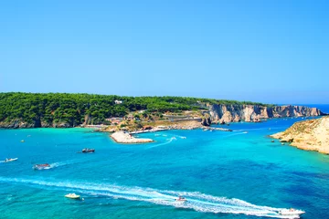 Foto op Plexiglas Impressive scenery from Tremiti Islands (Isole Tremiti) with the dulcet azure, emerald and blue hues of the Adriatic Sea crossed by many motorboats leaving white foamy wakes, a dock and rocky islands © Kristina Drozd