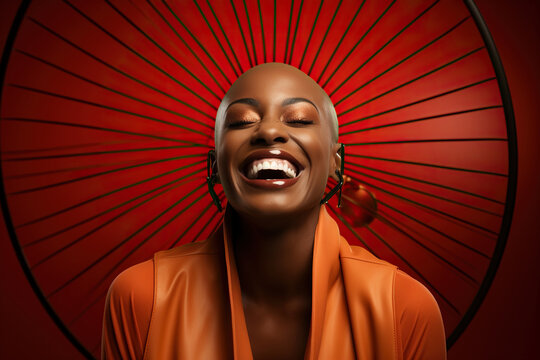 A black woman bald head smiling with big hoop