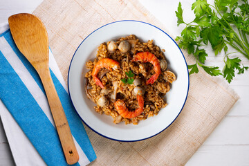 Spanish seafood paella with red shrimp and clams.