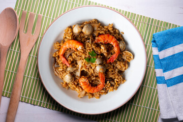 Spanish seafood paella with red shrimp and clams.