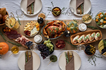 Top view background image of festive dinner table with delicious rustic turkey dishes, copy space
