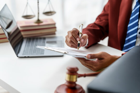 Business man hands close up working with contract lawyers specialize in dealing with the legal issues associated with the creation, negotiation and enforcement of contracts