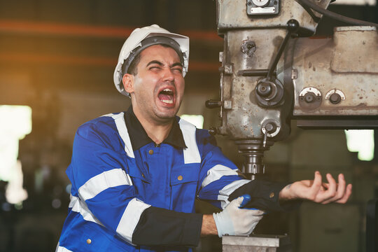 Factory male worker accident at his arms during working with lathe machine in industry factory