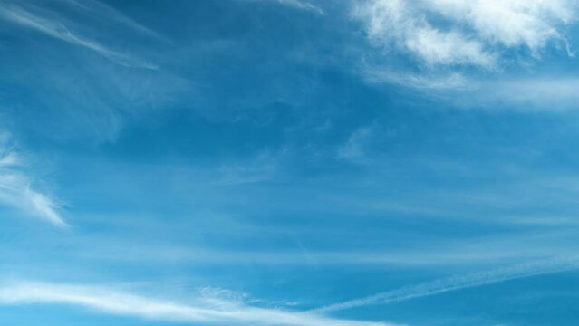 Time-lapse soft and blurry white clouds moving fast. Idyllic cloudy heaven abstract background. Timelapse clouds in blue sky on summer day. Place for title or logo