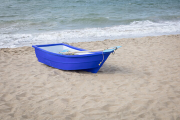 Blue rowing boat on the beach