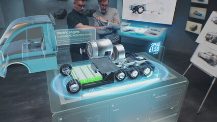 Two male automotive engineers create new eco-friendly truck with electric engine using futuristic...