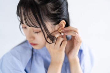 ピアスをつける女性