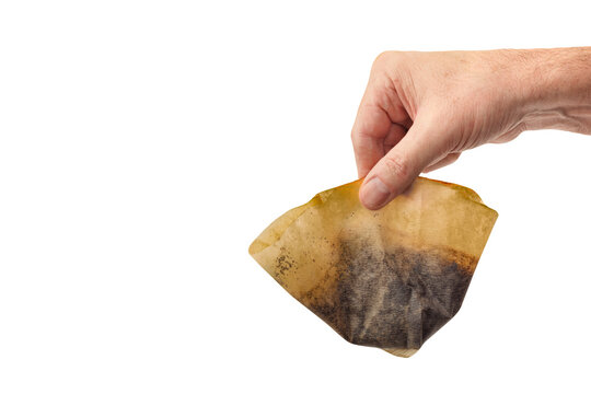 Discarding a used coffee filter isolated on white