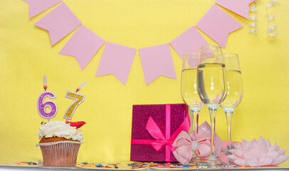 Date of birth with number 67. Festive pudding pie with a candle. Happy birthday decorations for a...