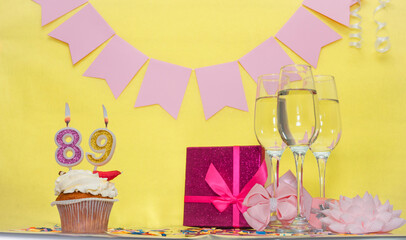 Date of birth with number 89. Festive pudding pie with a candle. Happy birthday decorations for a...