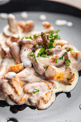 chanterelle julienne mushroom cream sauce appetizer meal food snack on the table copy space food...