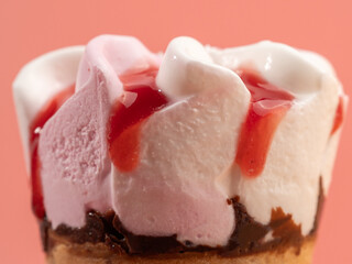 Strawberry ice cream in waffle cups. Ice cream on a pink background.