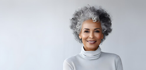 Beautiful african american senior woman portrait isolated on light grey background - Powered by Adobe