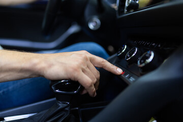 Naklejka premium Middle age man starts the car engine