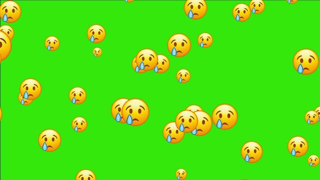 Crying emoji. Sad emoticon face with tear drop. Animated falling emojis. Social media icons symbol animation with green screen background.