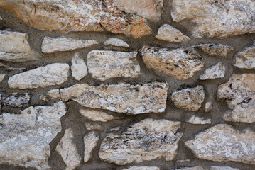 Old stone wall in Greece small town of Theologos as background