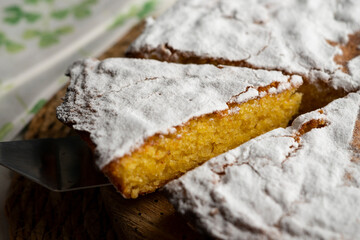 The Tarta de Santiago is the most typical sweet of Galician cuisine and is easily recognized by its emblematic Cross of Santiago in the center. - obrazy, fototapety, plakaty
