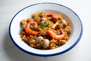 Spanish seafood paella with red shrimp and clams.