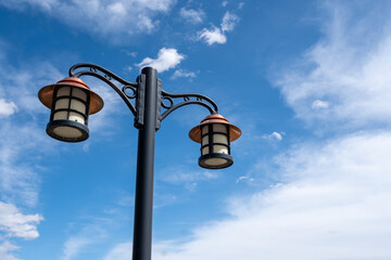 blue sky and worn vintage street lamp - 650738885
