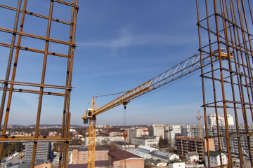 Fototapeta na wymiar A construction crane during work at a construction site