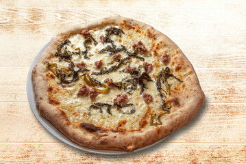 Pizza with sausage, chicory and cheese in plate on wooden table, top view