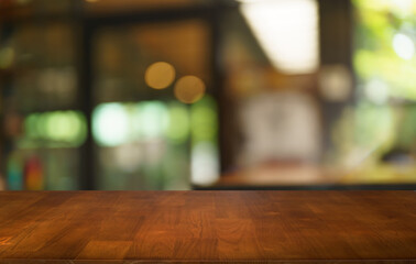 Mock up for space. Empty dark wooden table in front of abstract blurred bokeh background of restaurant . can be used for display or montage your product