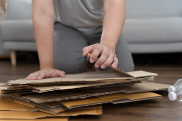Home recycle eco zero waste concept Man using recycle paper box. Stacking brown cardboard box eco friendly packaging made of recyclable raw materials.
