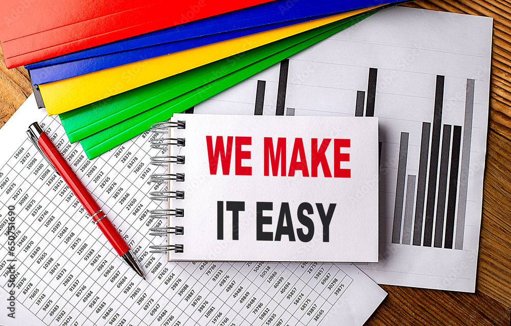Aufkleber we makeit easy text on notebook with pen, folder on a chart background