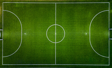 Top down aerial view of an empty soccer field, awaiting the joyous moments of the game.