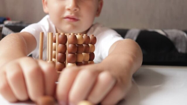 logic wooden board game and a boy playing with it close-up