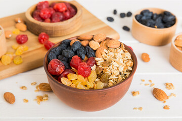 Cooking a wholesome breakfast. Granola with Various dried fruits and nuts in a bowl. The concept of...