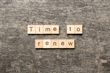 time to renew word written on wood block. time to renew text on table, concept