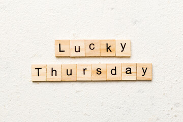 lucky thursday word written on wood block. lucky thursday text on cement table for your desing, concept