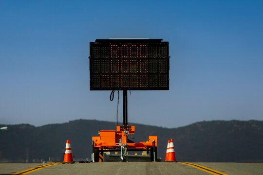 Horizontal Image Of A Digital Road Sign Stating Road Work Ahead Against A Blue Sky