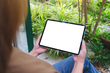 Mockup image of a woman holding digital tablet with blank white desktop screen