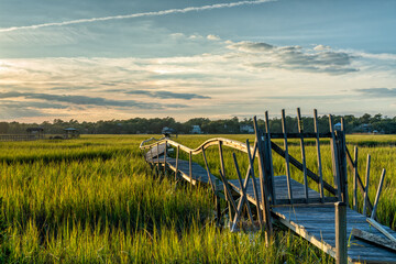 old dilapidated wooden dock in the marshgrass and inlet of Palweys Island in South Carolina