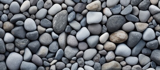 Gray pebble rocks create a natural stone texture wall background isolated pastel background Copy space - obrazy, fototapety, plakaty