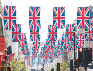 London: Union flags on display above Regent Street, a landmark shopping destination in London’s...