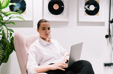 Female director using computer while working on project