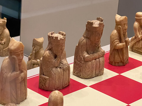 The British Museum display of The Lewis chessmen, group of distinctive 12th-century chess pieces, along with other game pieces, most of which are carved from walrus ivory.