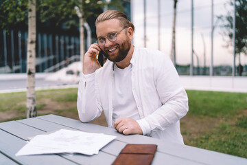 Cheerful man talking on smartphone