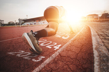 Athletes who start running on a rubber track with a bright sunset, blurred background. Ideas for starting something new, starting a new thing, starting a successful one, leading an organization	 - obrazy, fototapety, plakaty