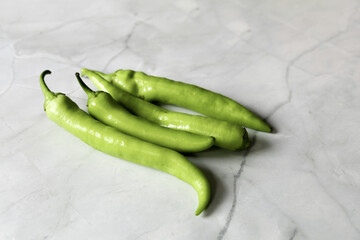 A bunch of green pepper pods. Hot chili pepper.