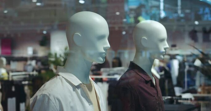 clothing on mannequins in a mall or in a fashion store window. clothing on mannequins concept in a fashion store. Mannequins in men's clothing stand in the mall.