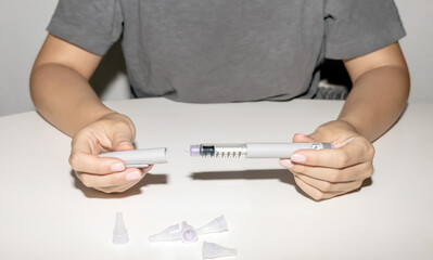 Female hands holding an insulin pen. Ozempic Insulin injection pen.