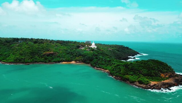 Drone hovering over ocean, beach, jungle, and temple. Perfect for travel, nature, and cultural content. Aerial views of serene beauty.