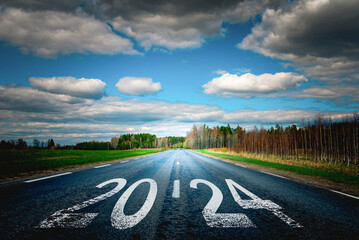 Entering the new year 2024.Start plan for 2024.The year 2024 is written on the asphalt road.Concept...