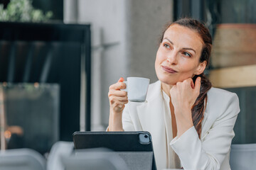 business woman drinking coffee with laptop