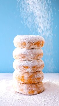 Dusting Powdered Sugar Donuts